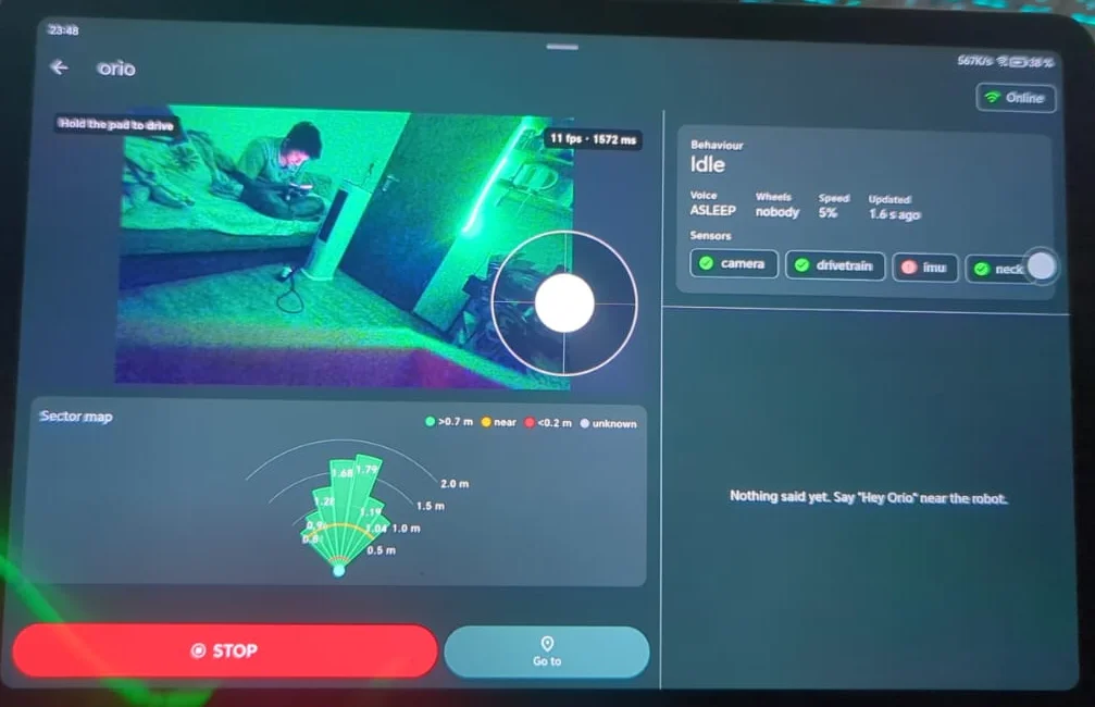 The Orio app on a tablet: Orio's live camera view with a drive pad over it, a map of how far away nearby obstacles are, a stop button, and the robot's status and sensors