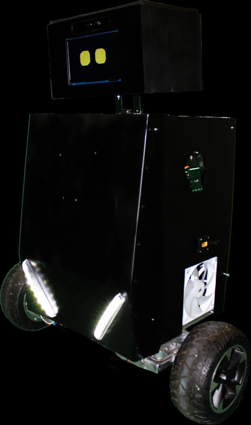 Orio's working prototype: a black two-wheeled robot with a screen face showing two yellow eyes, a depth camera above the screen, and light strips at its base
